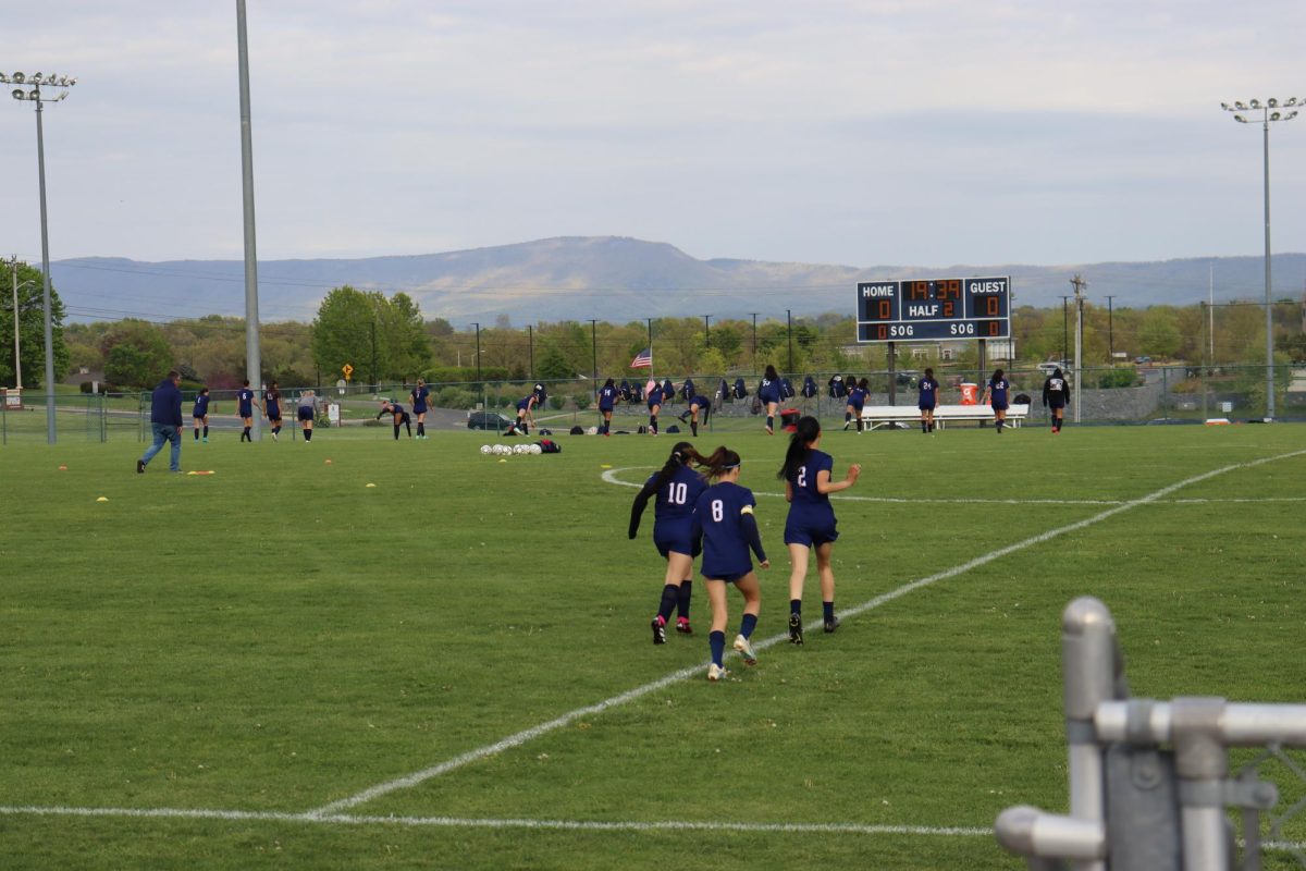 Sophomore Sara Hussein, Ana Figueroa, and Lisette Bueno warm up before the game. 