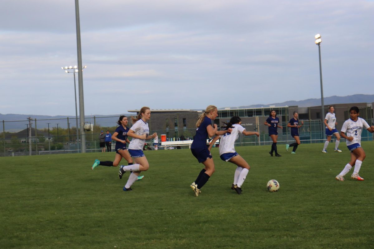 Freshman Katherine Schwartz runs to kick  the ball.  