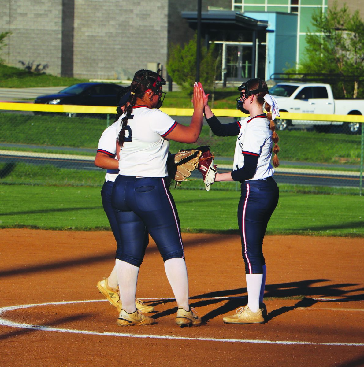 Senior Camryn Johnson gets congratulated by her teammates, Senior Idaly Alvarez and Junior Kayli Alvarado. 