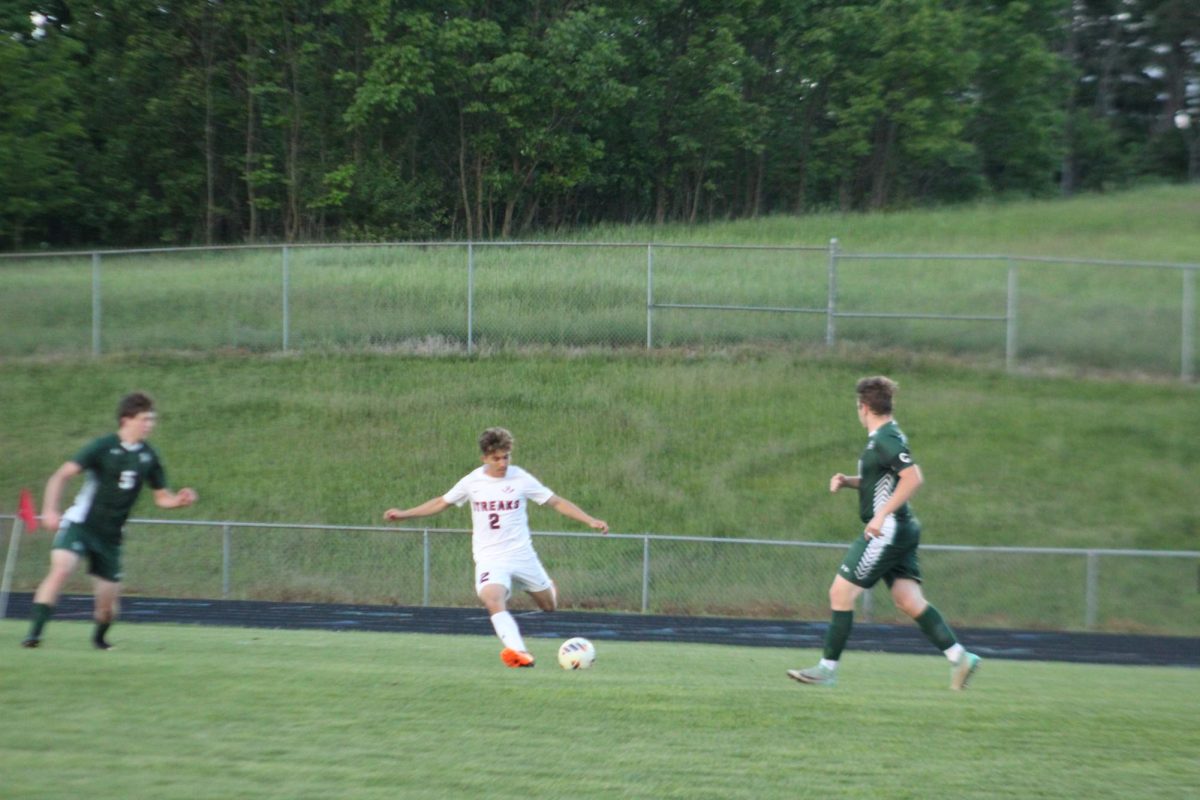 Izaack Cruz crossing the ball in between Broadway players.