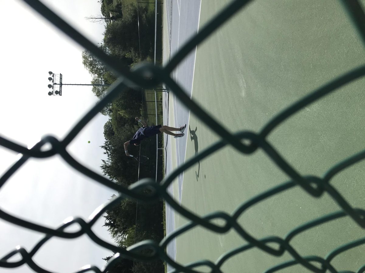 Louis Gibson serves against the Massaponax 3rd seed player.