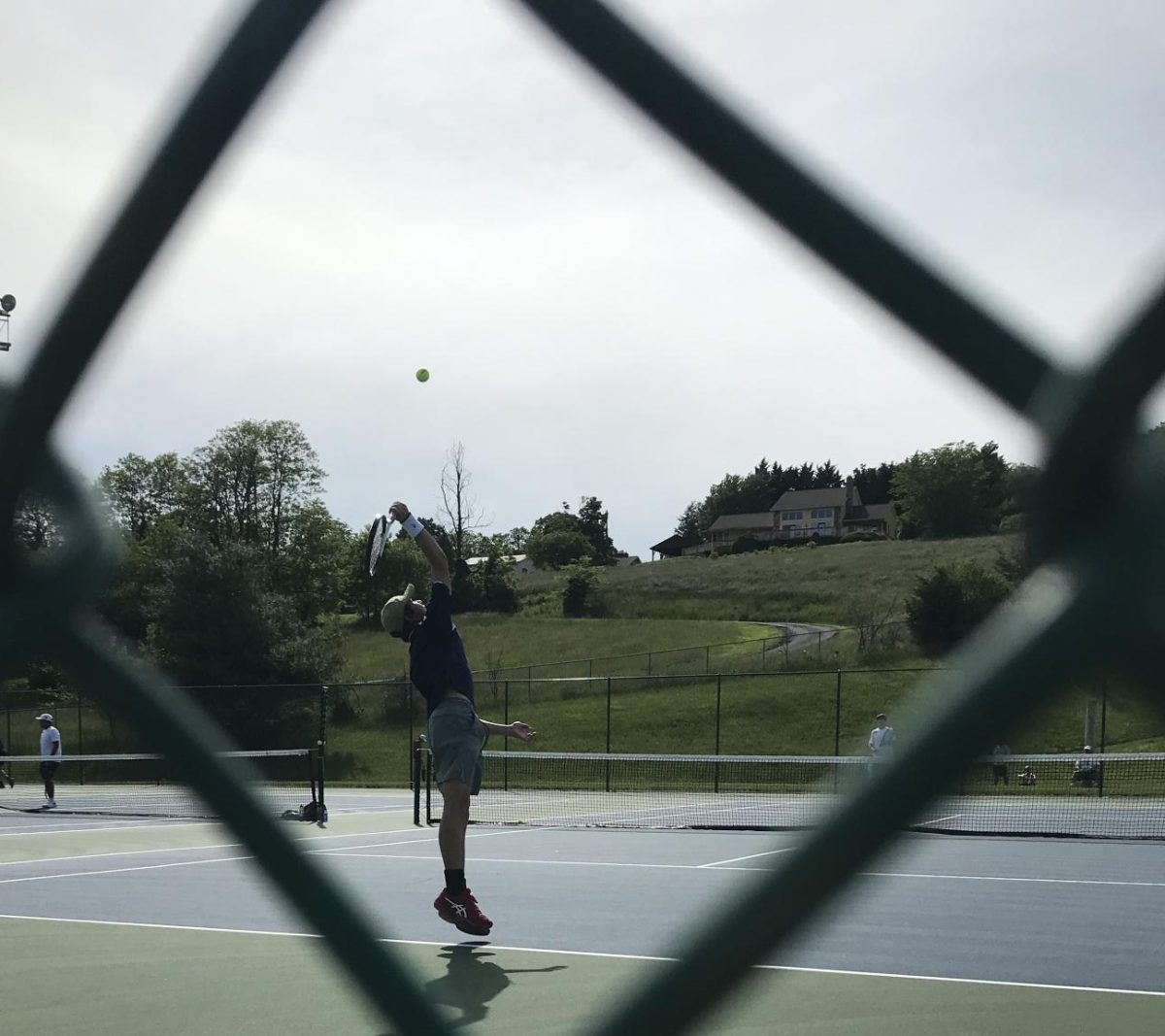 Brody Beshoar serves against the Massaponax 2nd seed player.