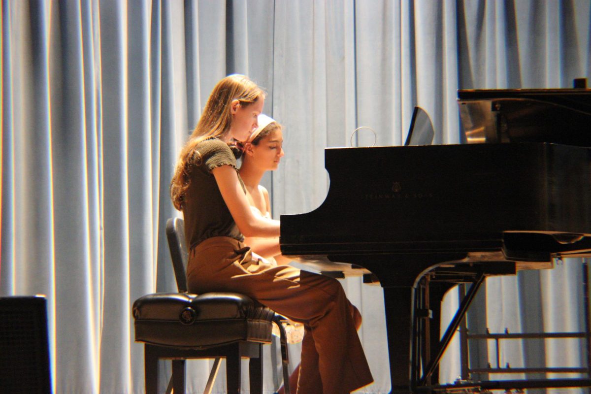 Junior's Ellie Wiley and Eliza Malcolm perform a duet on the piano.