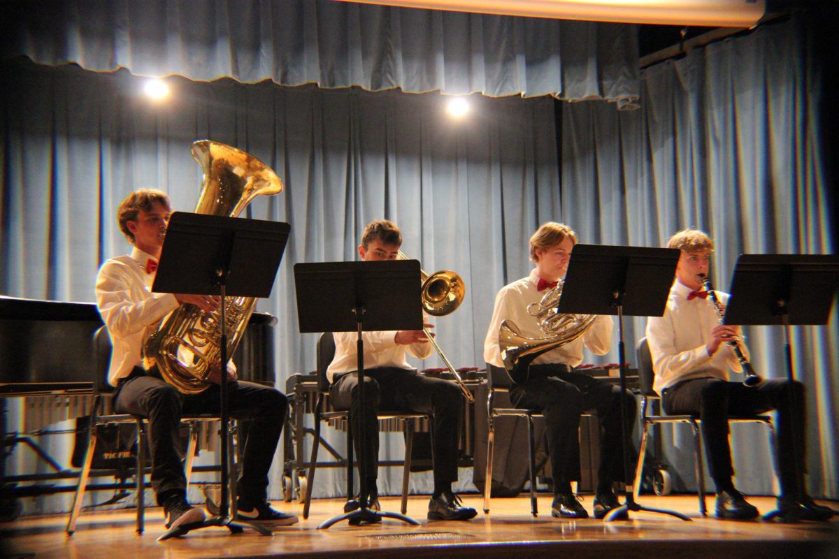 Senior's Andrew McMichael, Ryan Quimby, Matthew Rush, and Junior Lucas Swartz perform a group piece to "Puttin' On the Ritz."