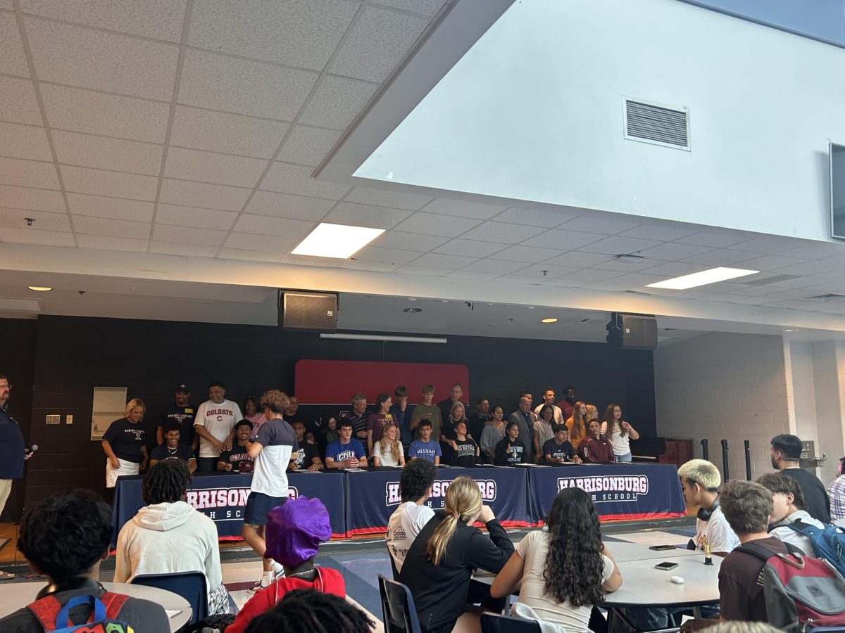 All athletes and parents take the stage and take a group photo. 