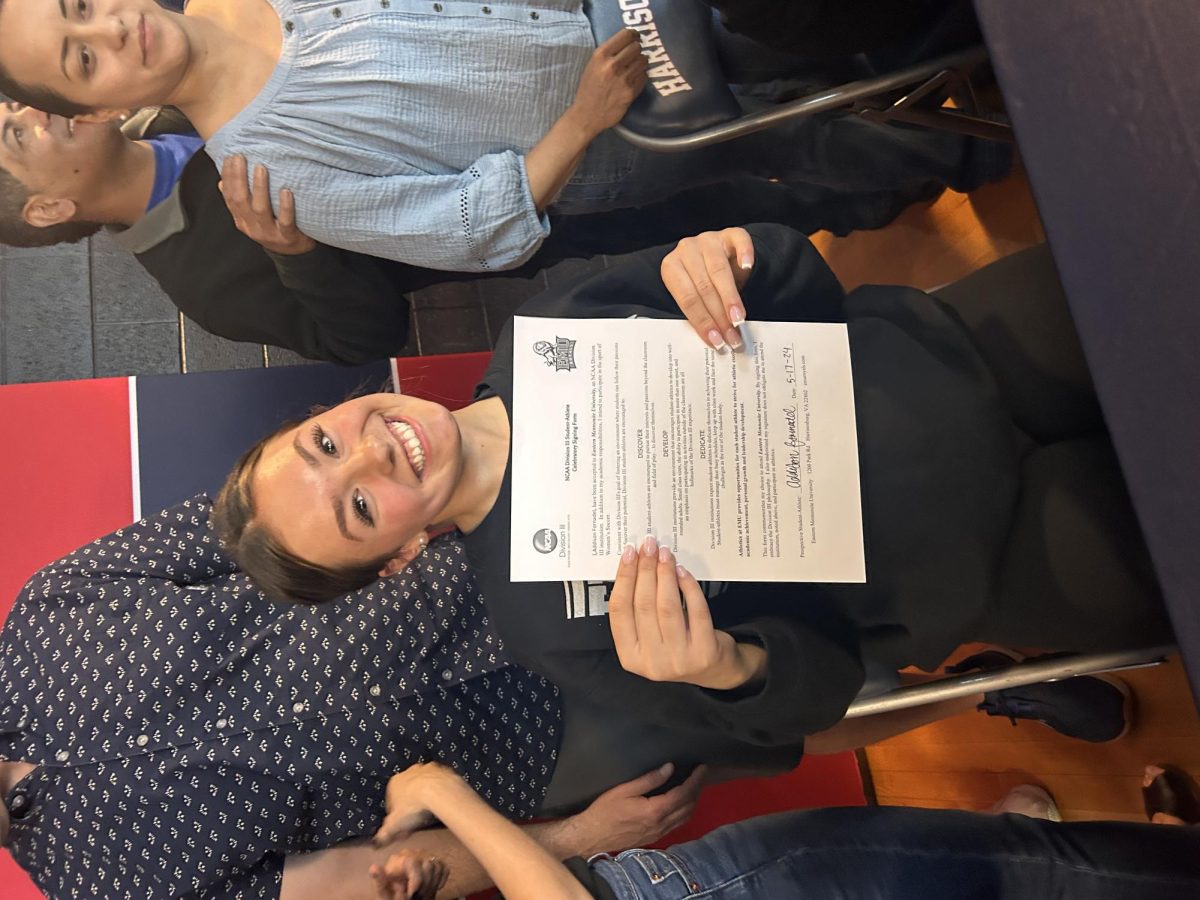 Senior Addison Fornadel holds up her commitment letter to EMU women's soccer. 