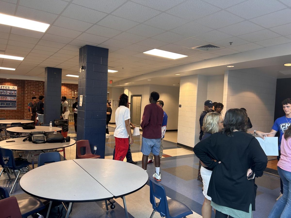 Students gather around to congratulate their friends on signing day. 