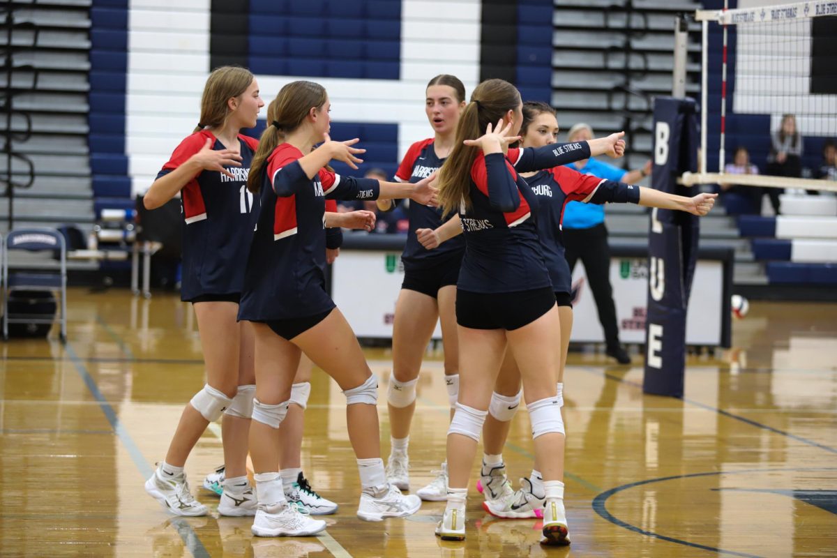 The volleyball team celebrates with their "Ace" cheer after getting an ace. 