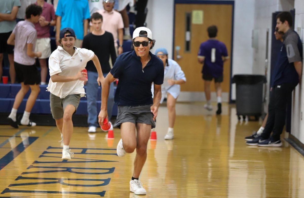 Senior Javier Molina runs in a relay race. 