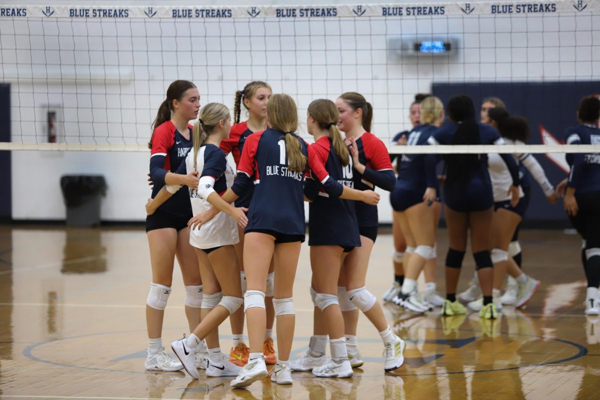 The team huddles after losing a point. 