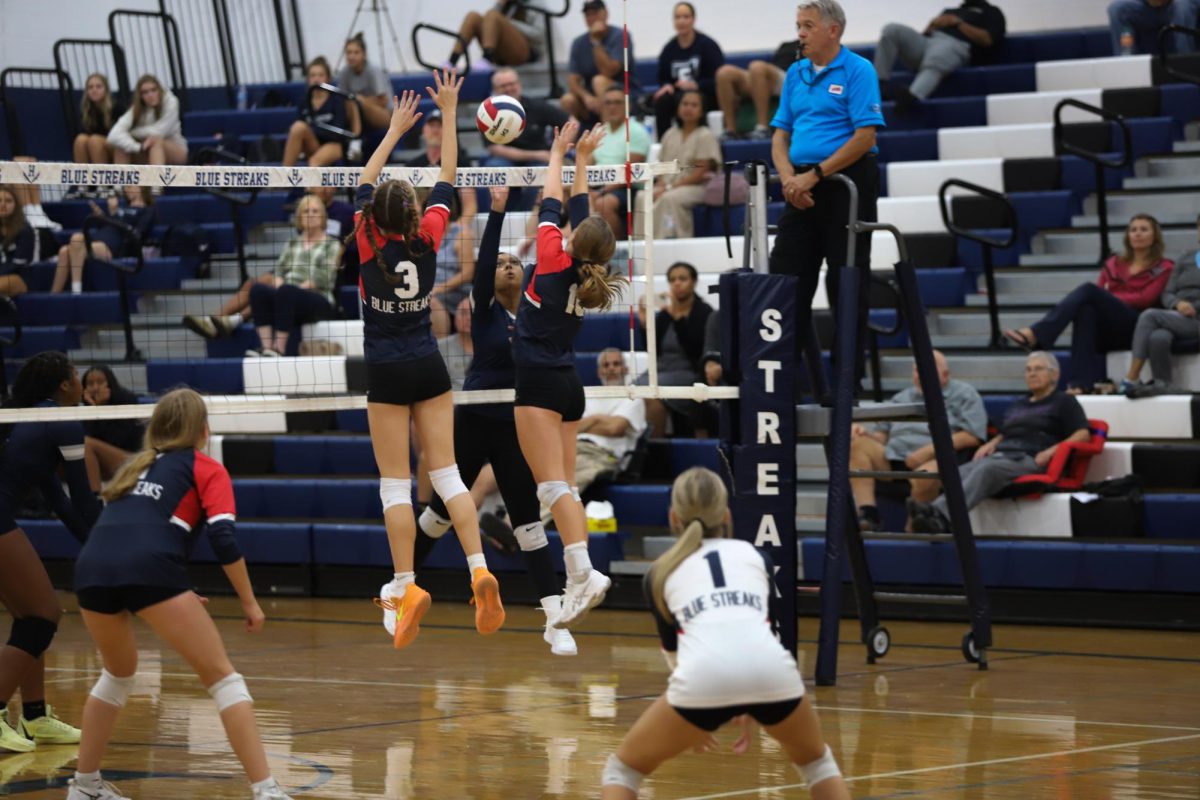 Senior Macy Waid and sophomore Brynn Smith jump to block the ball. 