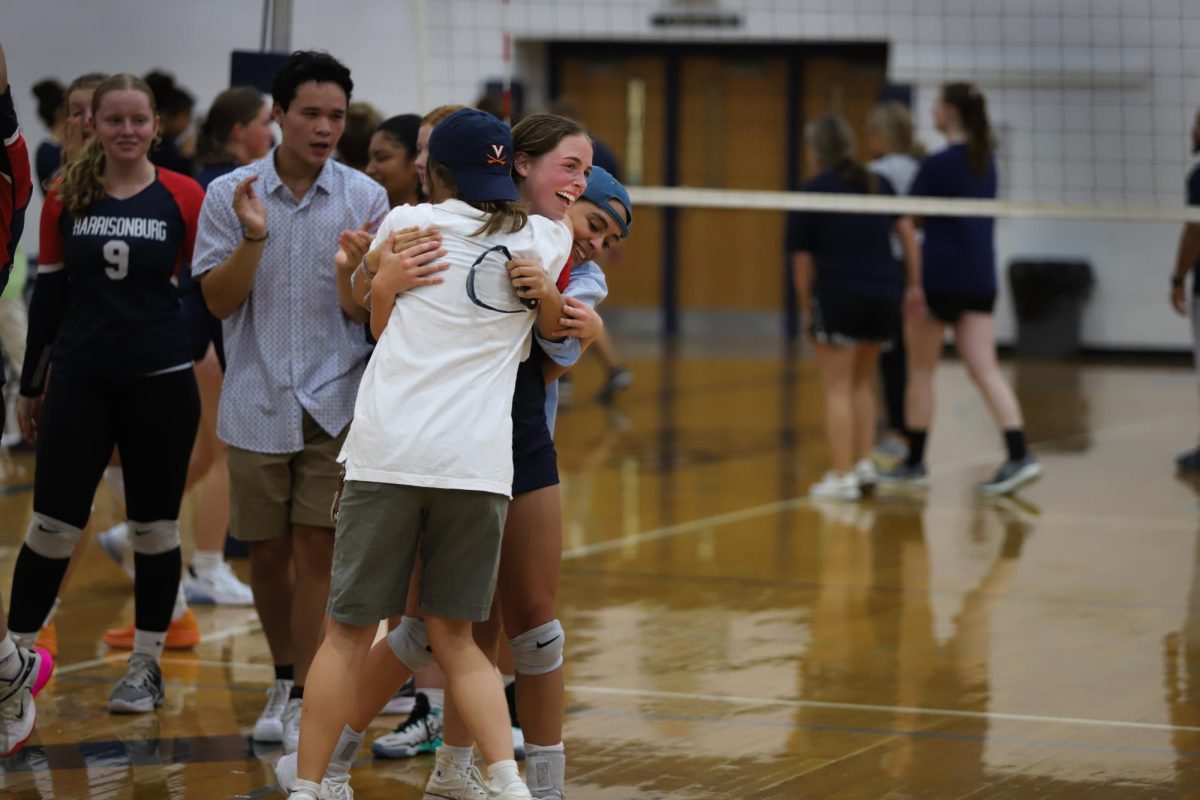 Seniors Lydia King hugs player Macy Waid after the game.