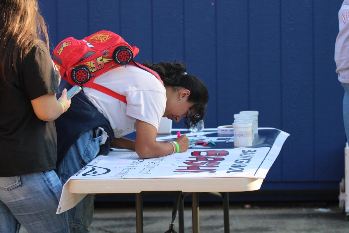 Students signed a banner during the Back to School Bash..