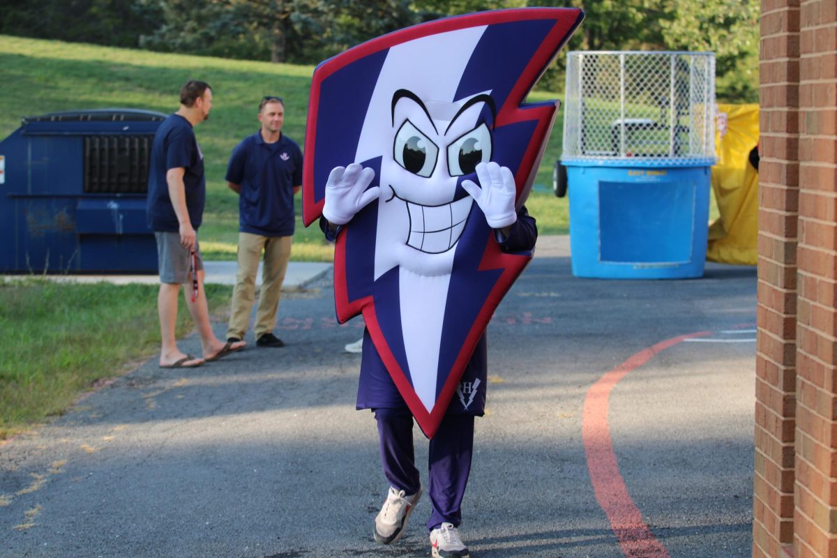 Bolt, the new mascot, waves to students.