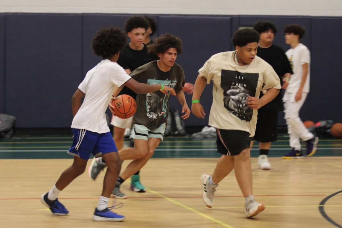 Students play basketball at the open gym during the Back to School Bash.