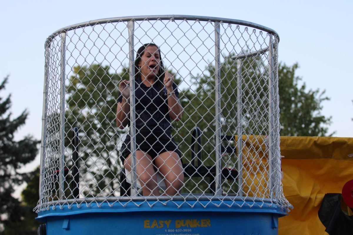 Assistant principal Gloria Figueroa-Vargas falls into the dunk tank at the Back to School Bash. 