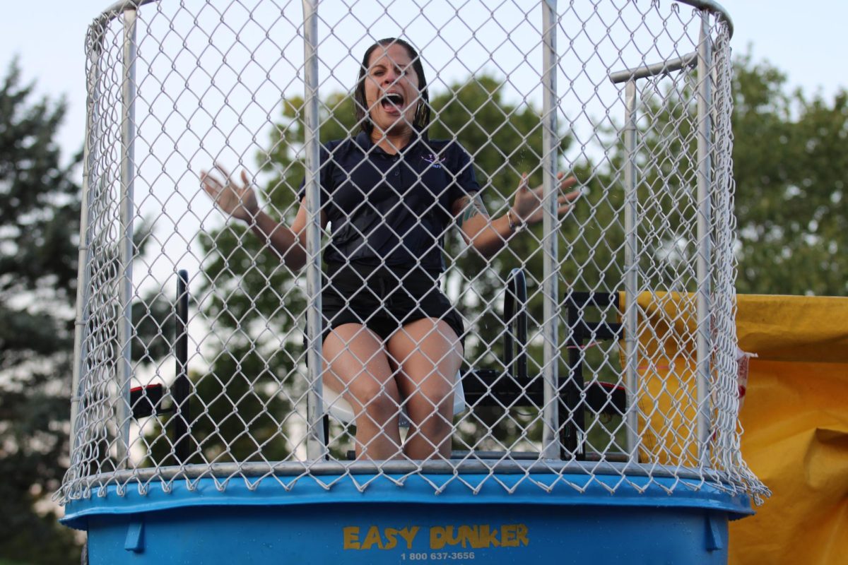 Assistant principal Gloria Figueroa-Vargas screams as she falls into the dunk tank.  