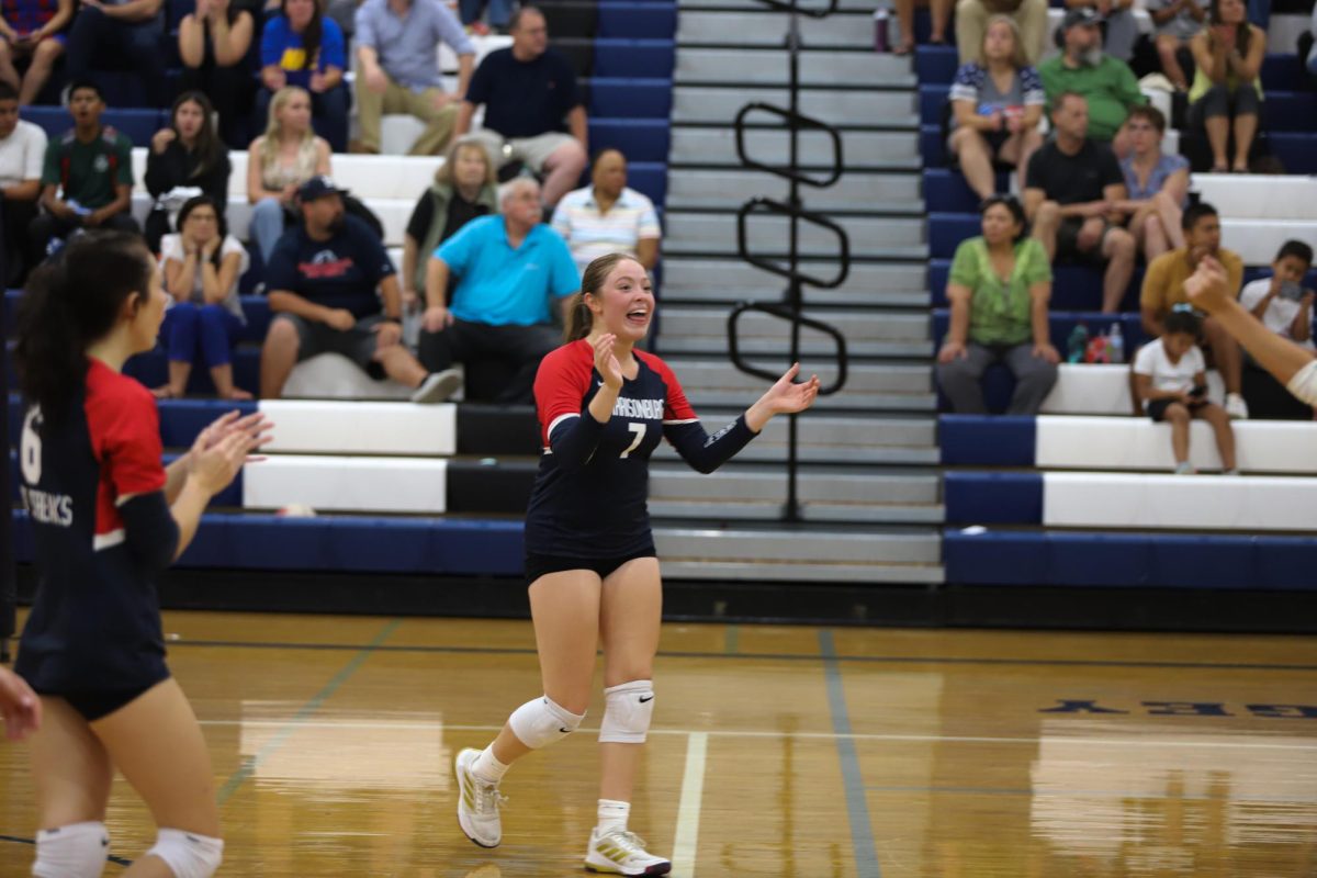 Senior Veronica Gutierrez cheers after winning a point.