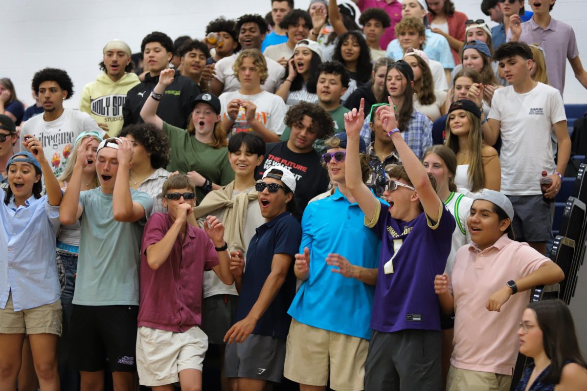 The Red Sea celebrates after making a ball in a cup during their cup pong game.