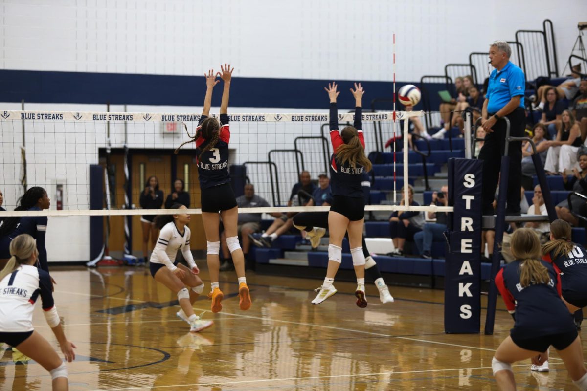 Senior Veronica Gutierrez and sophomore Brynn Smith jump to block the ball.