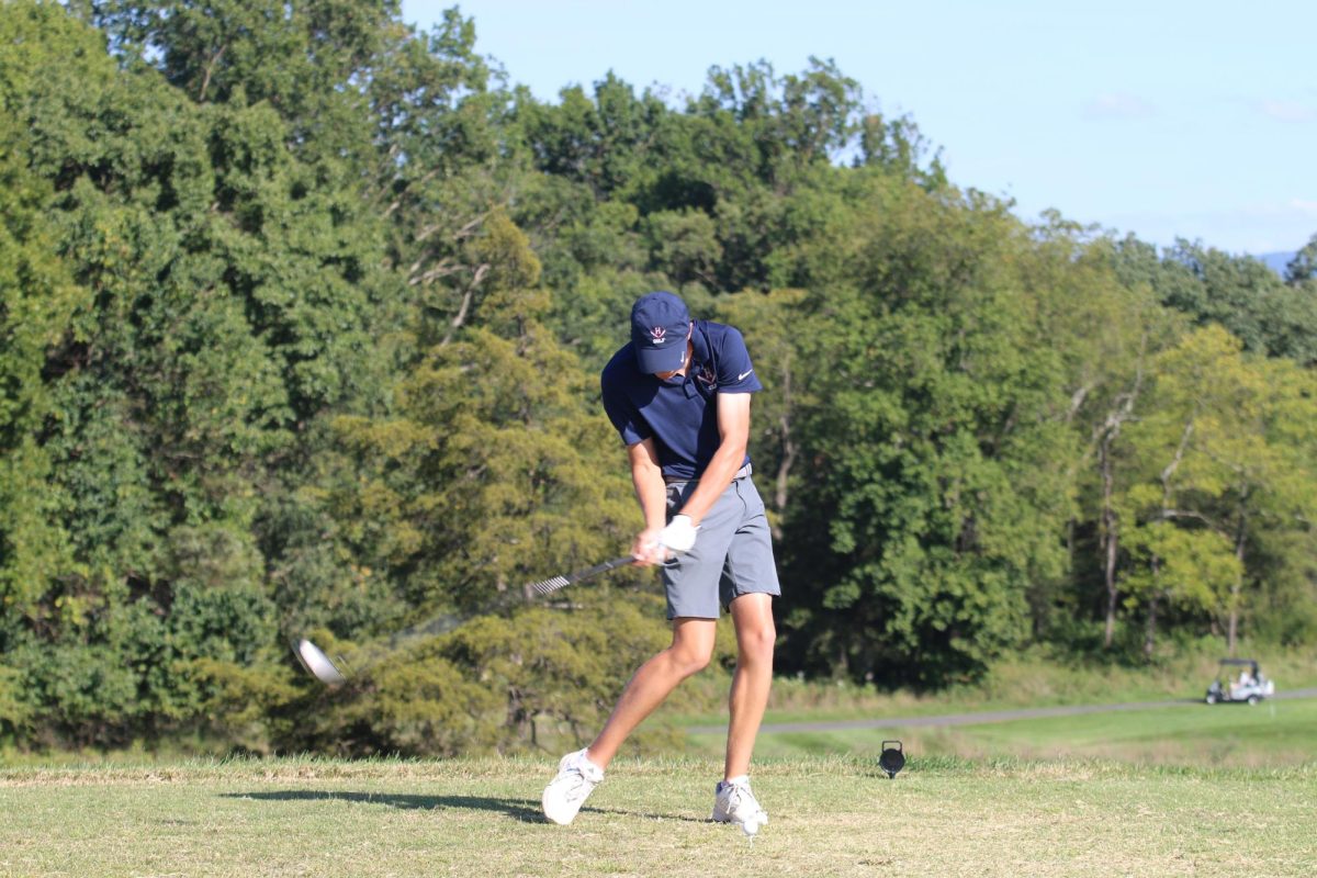 Sam Maust hitting the ball.