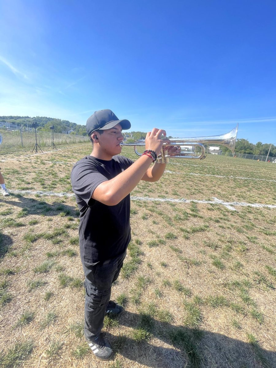 Sophomore AJ Mendoza plays his trumpet at band rehearsal.