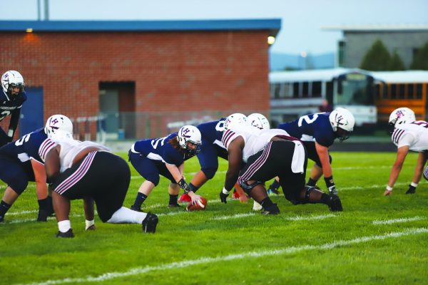 Varsity football team plays against John Handley,  losing 54-6.