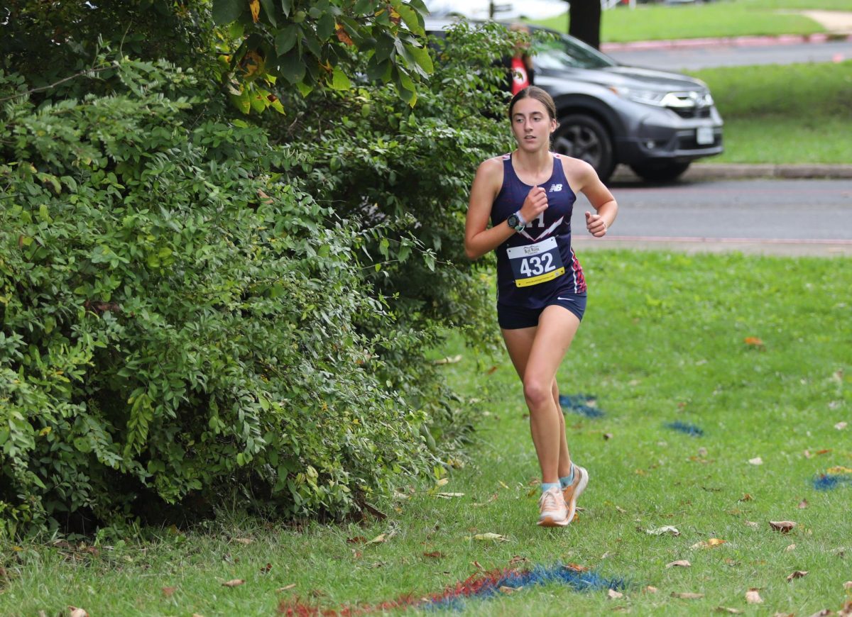 Sophomore Bethany Rush sprints up a hill known as "Big Bertha" on her first lap during a home race at Thomas Harrison.