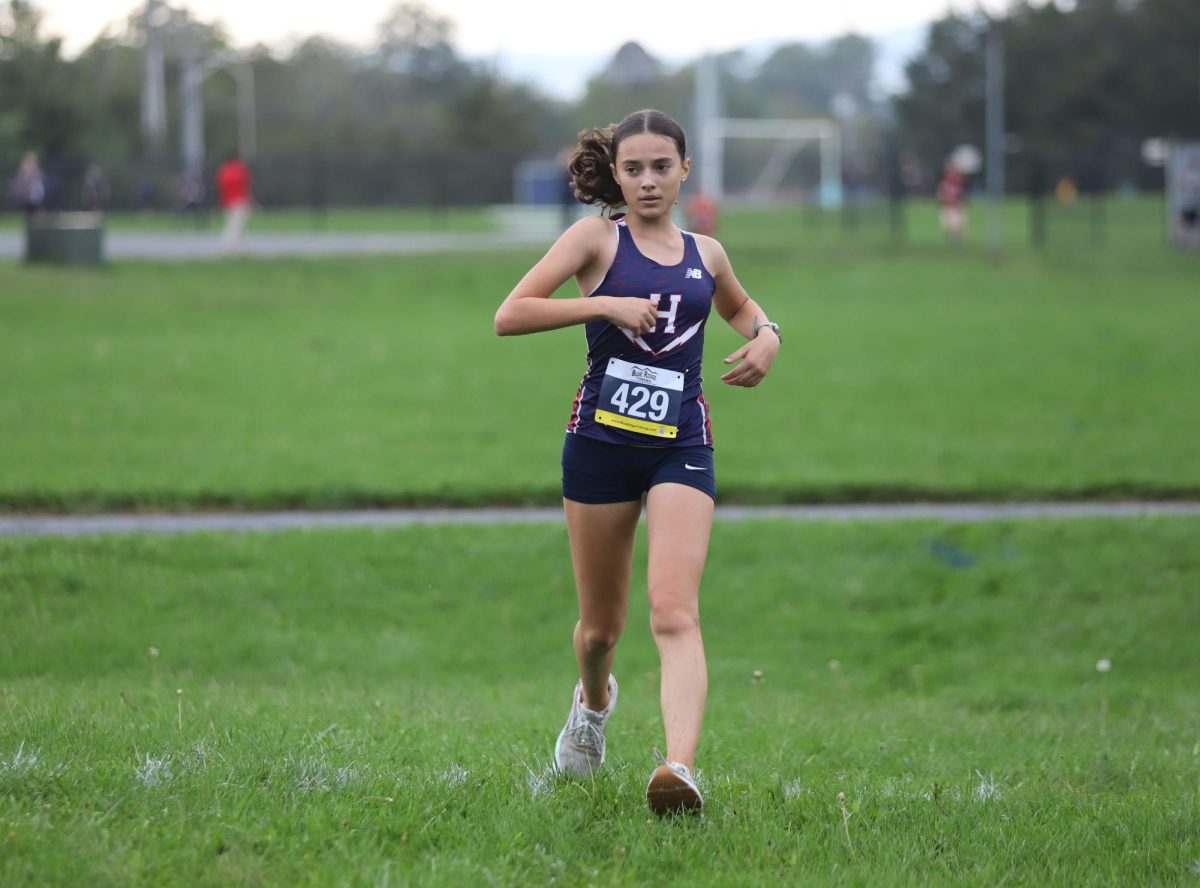 Freshman Eliza Godshall takes a breath after finishing her race.