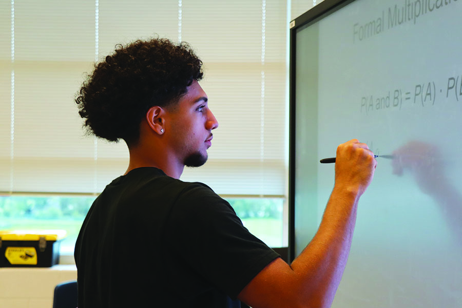 Senior Filipo Toelau solves a math problem in DE Statistics.