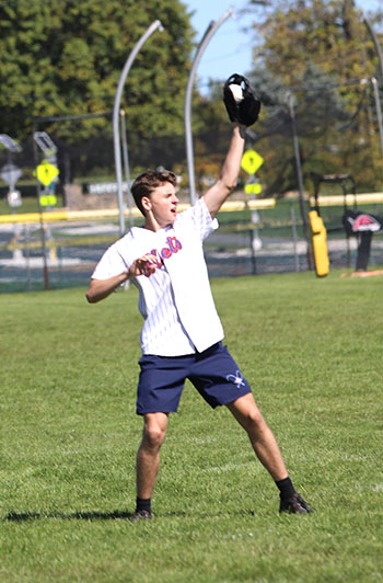 Senior Louis Gibson catching the baseball.