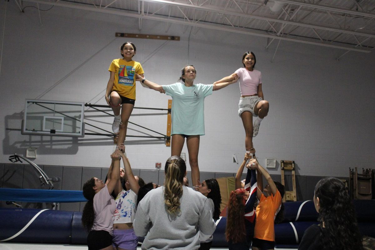 Freshmans Gretel and Mirna in a extended lib as Freshman Danica braces them.