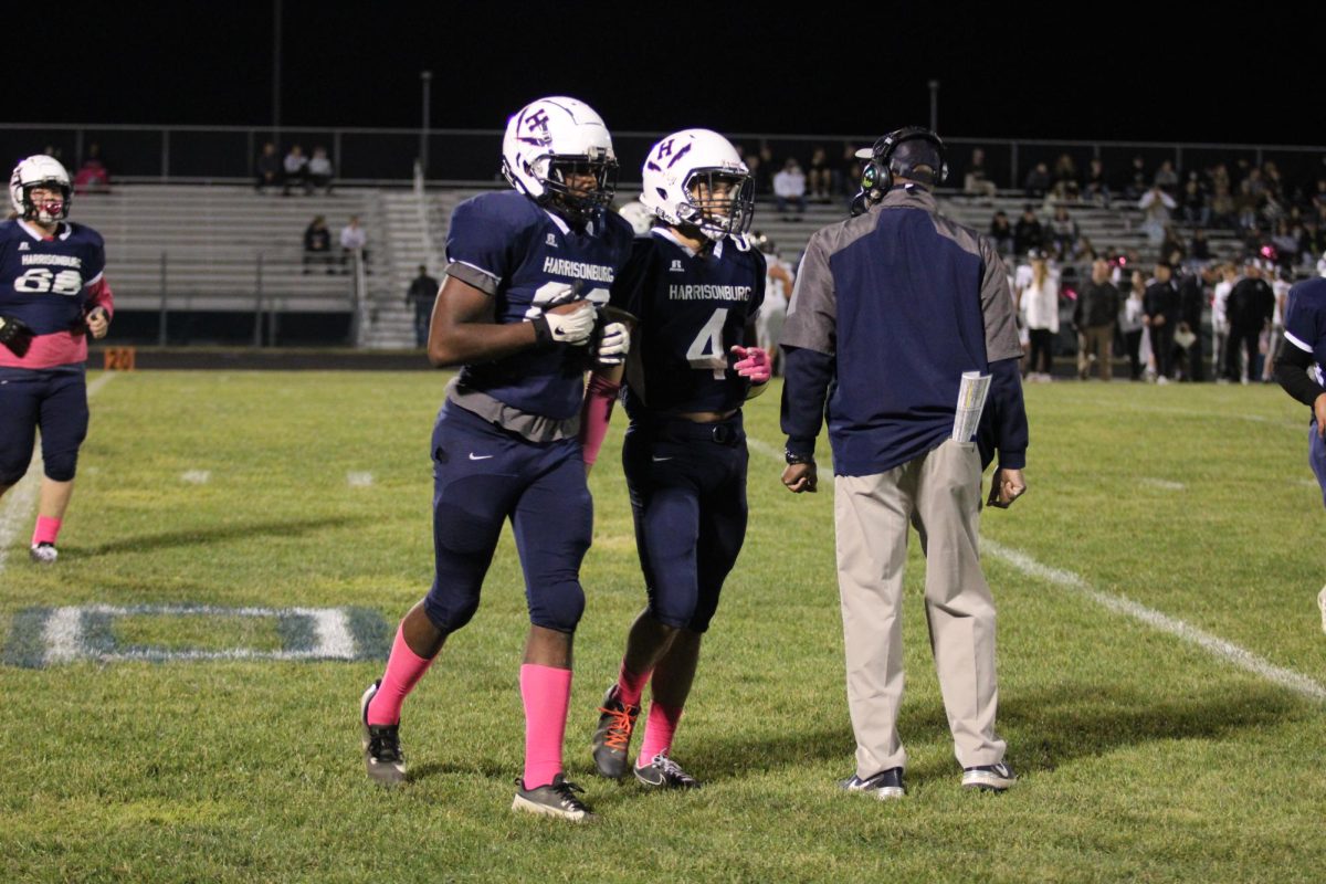 Seniors Mason Smith and Lazaro Valdivia run off the field during a substitution.