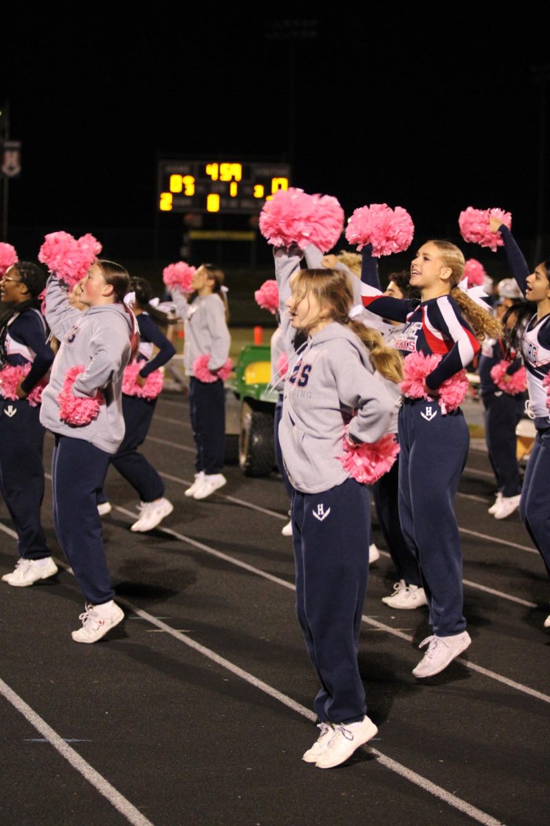 Sideline cheer pumps up the crowd while the Blue Streaks drive down the field.