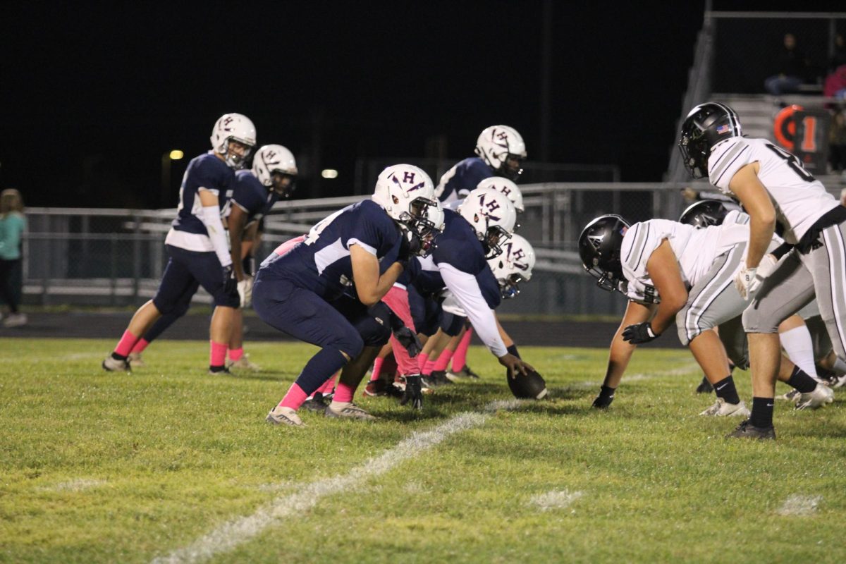 The Blue Streaks offensive line gets ready to snap the ball and run a play.