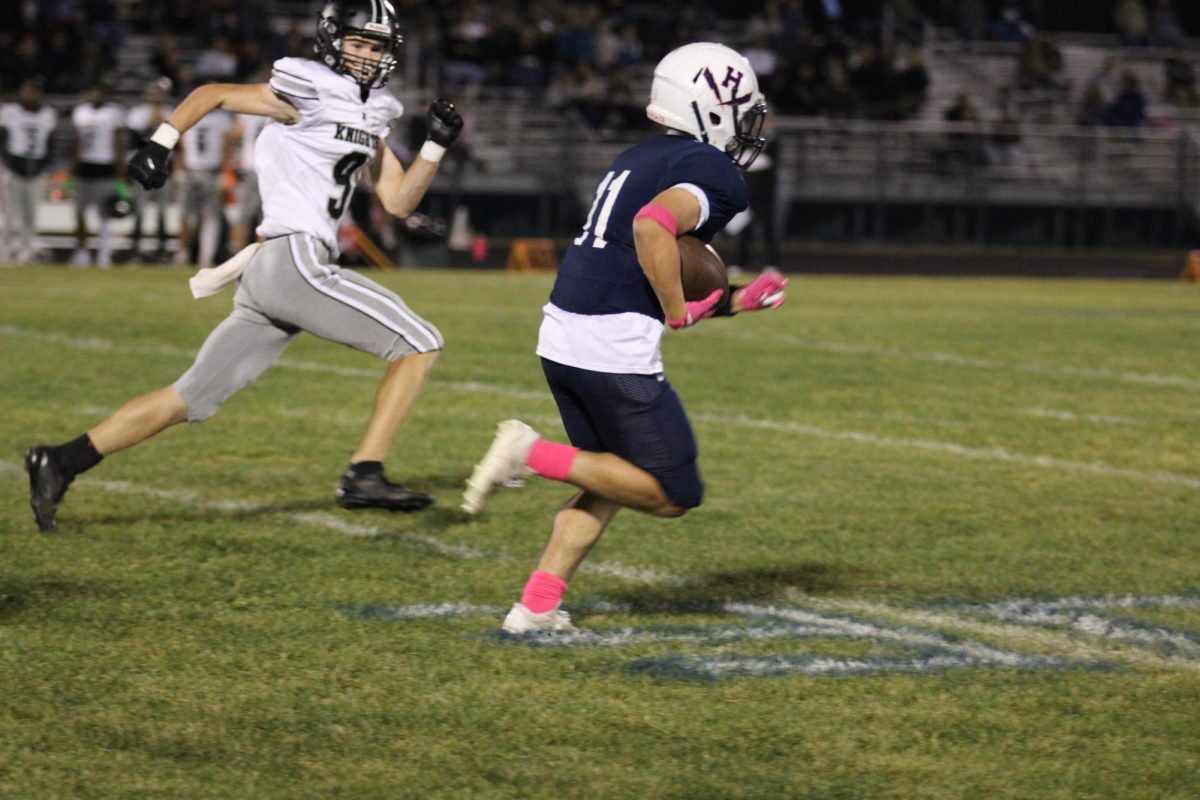 Junior Fernando Rodriguez runs past a Knights defender on his way to the endzone.