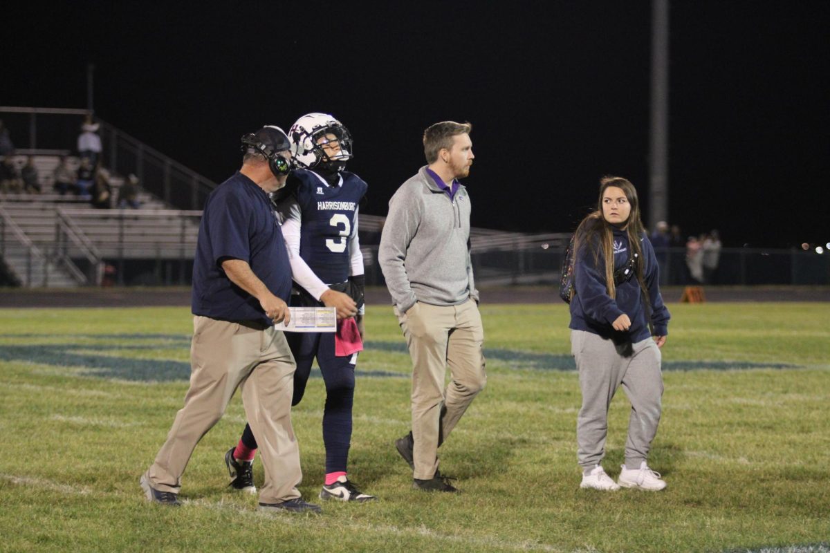 Sophomore Yandel Robles walks off the field with the trainers after an injury scare.