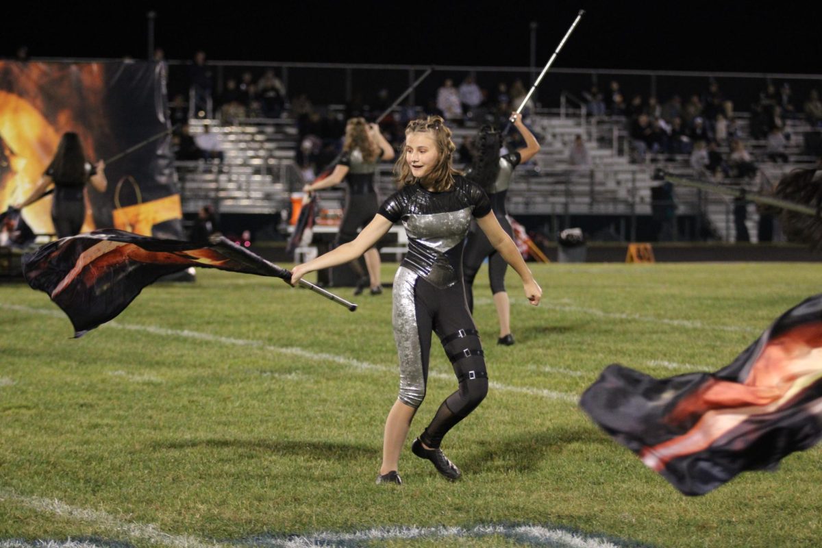 Sophomore Quinn Webb dances with the color guard. 