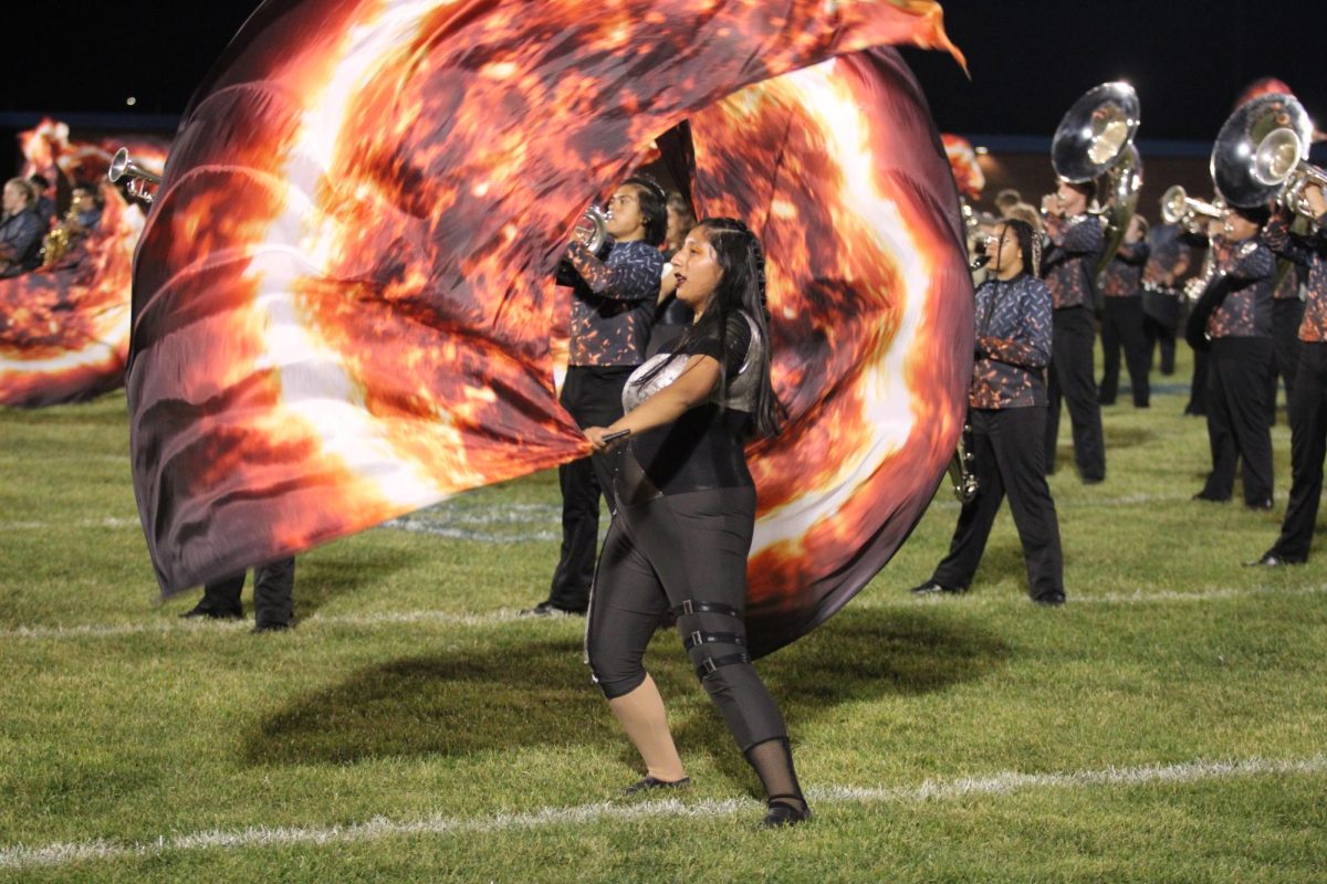 Color guard uses fire inspired flags. 