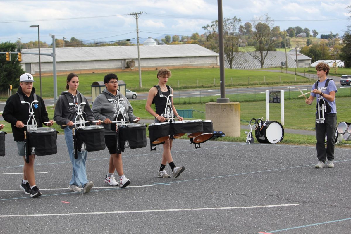 Drum line practicing marching. Junior Billy Perritt is leading the drum line.