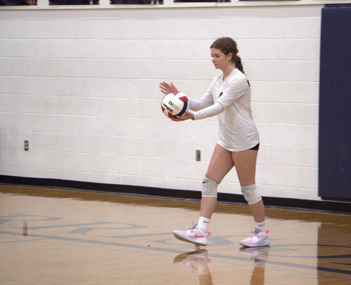 Kyleigh Morris approaching to serve the ball.