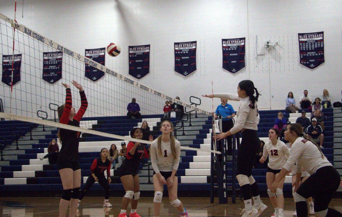 Leah Yoder in the air after she hit the ball.