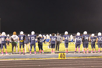 Football players standing on a line