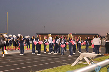 Sideline cheer facing the football field.