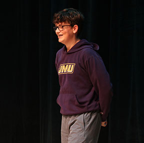 Sophomore Shea Gibson explains an improv game to the audience.