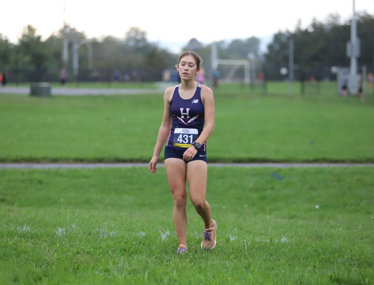 Junior Sophie Kauffman rests and checks her racing time after finishing her last lap.