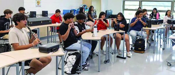 Junior Carlos Lopez (far left front) practices his clarinet with the rest of the woodwinds section. The band practiced inside when the temperatures on the field topped 100 degrees during the first weeks of school. 