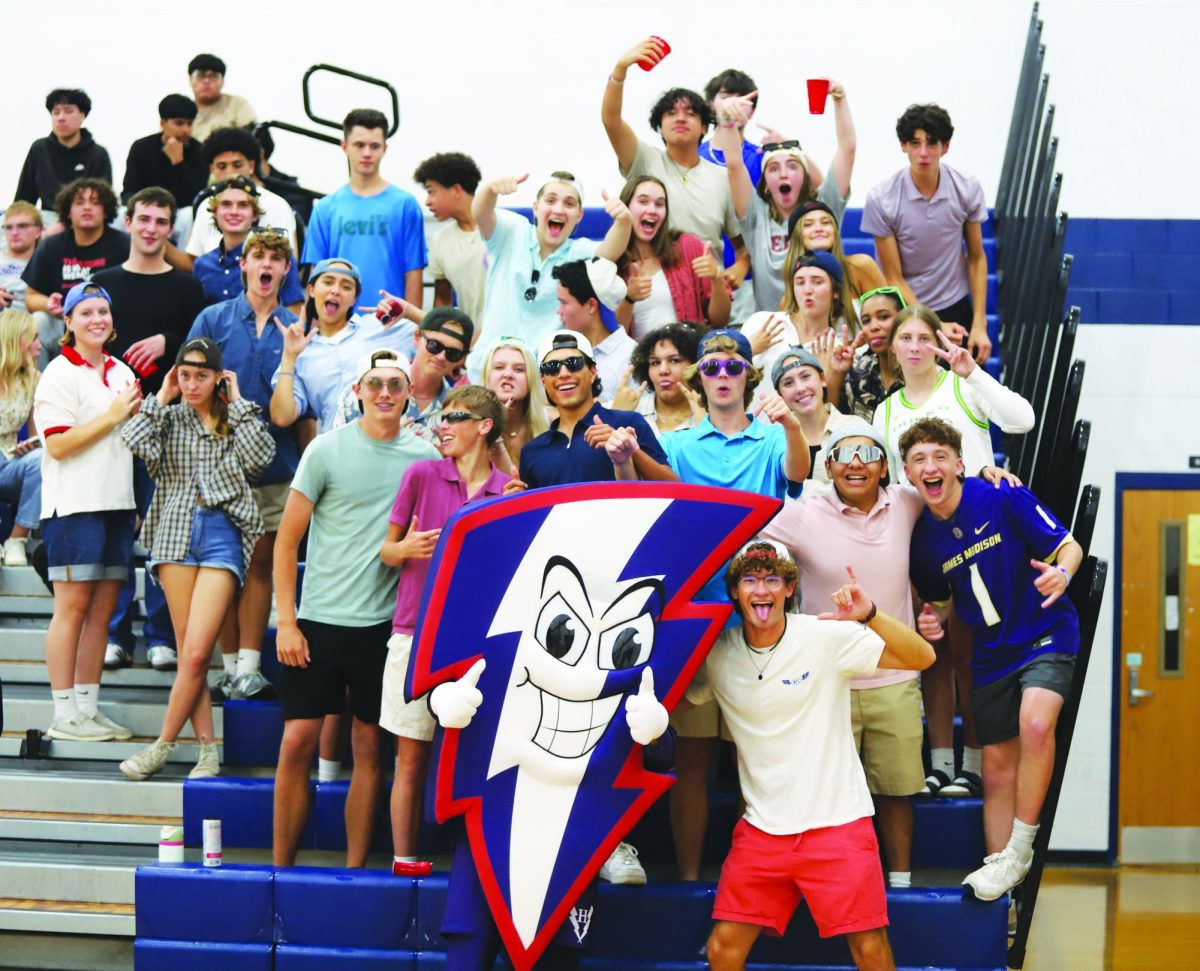 New mascot, Bolt, cheers with the student section during a varsity volleyball game.