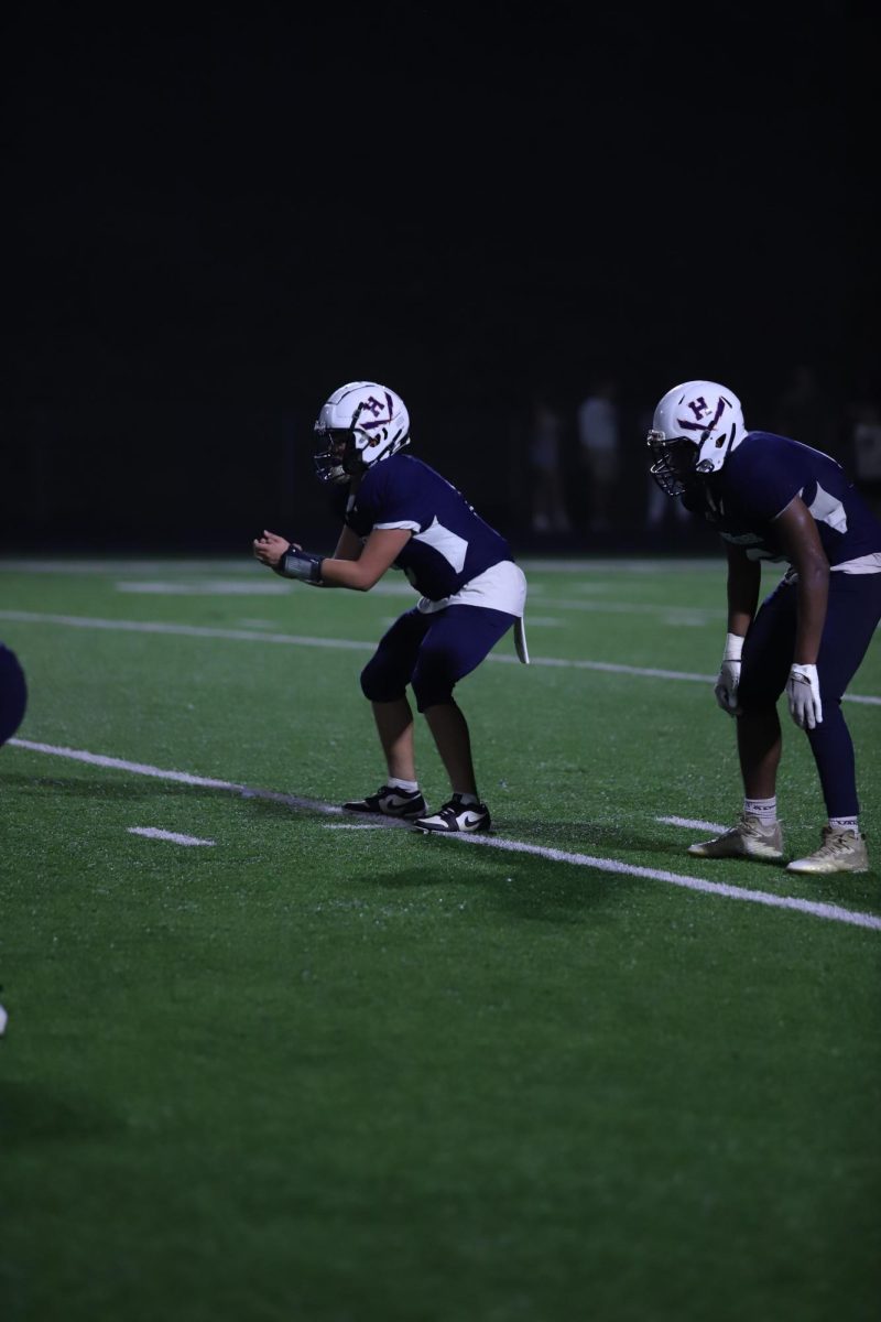 Junior Edwin Martinez and his teammate get in set position to snap the ball.