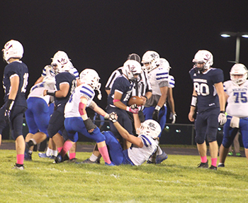 HHS football team helping a wildcat player up